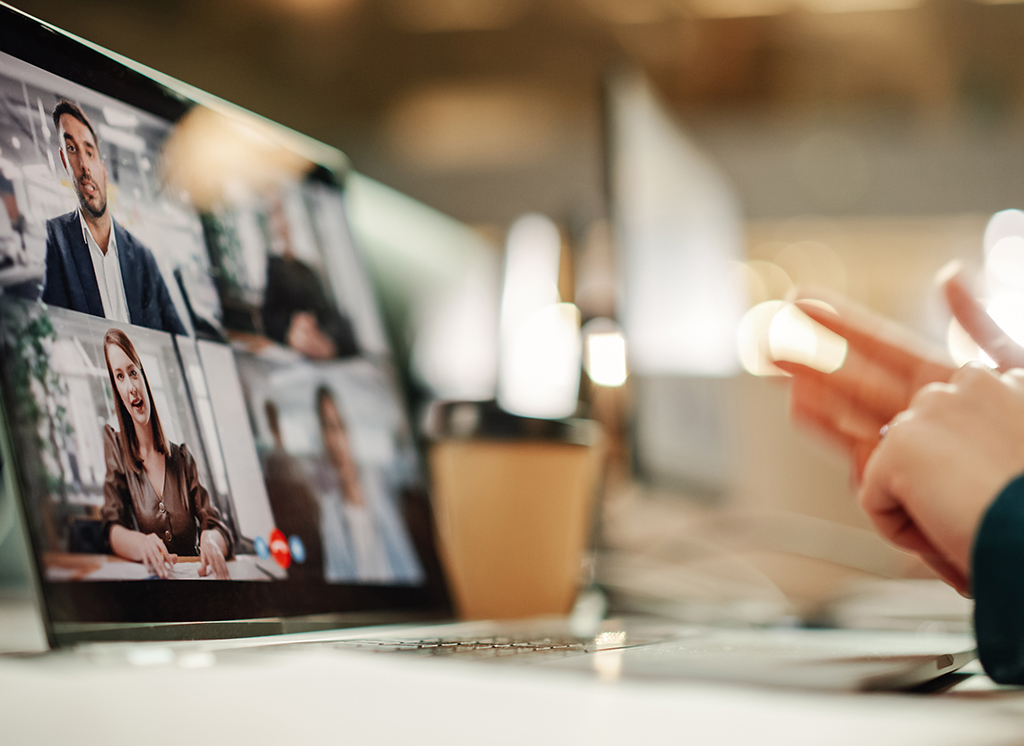 A laptop displaying a video conference with multiple participants, representing remote collaboration on accessible document projects.